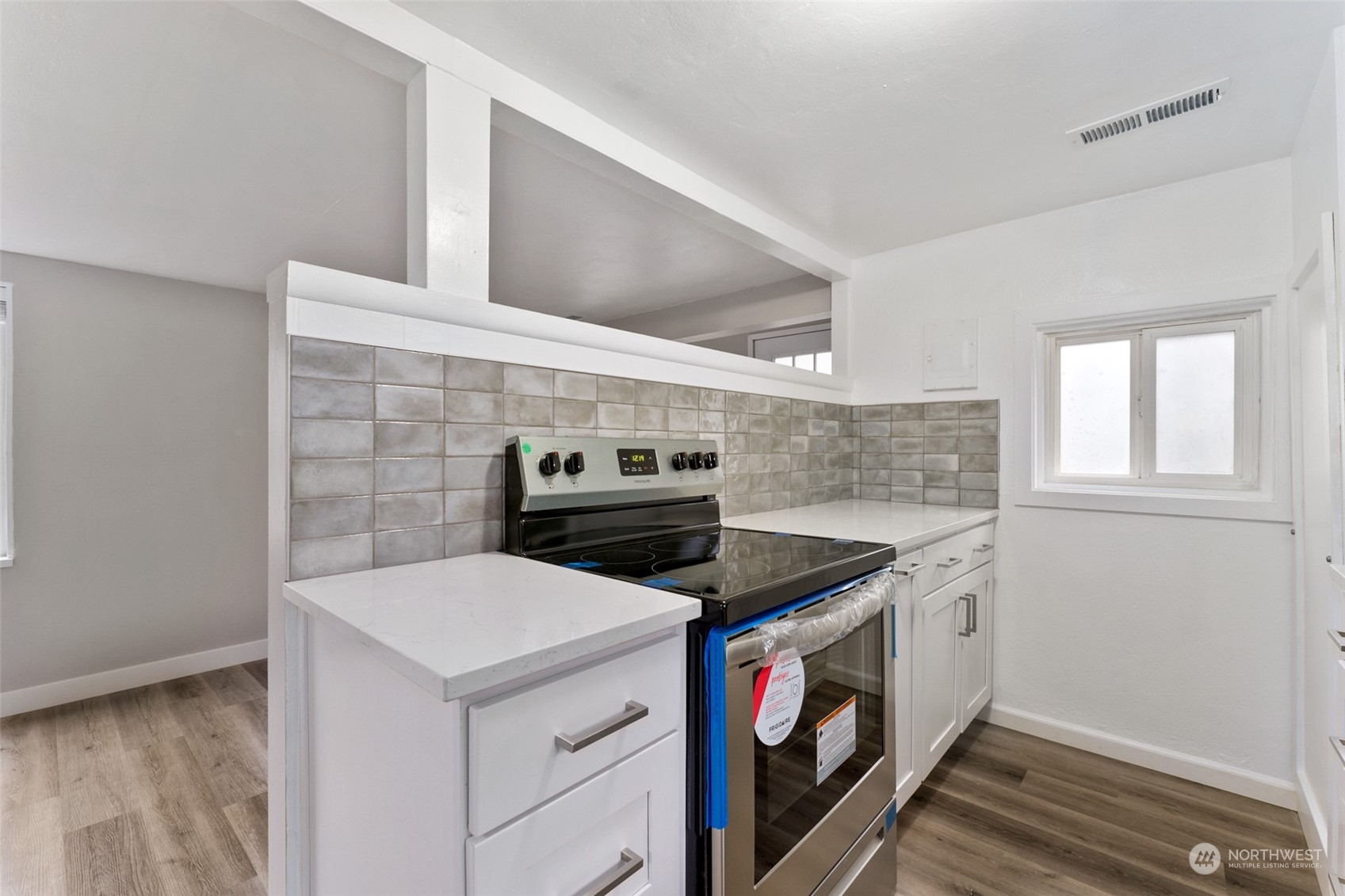 8520 Meadow Road Southwest Lakewood, WA 98499 - Photo 7 of 24 a kitchen with a stove and a microwave