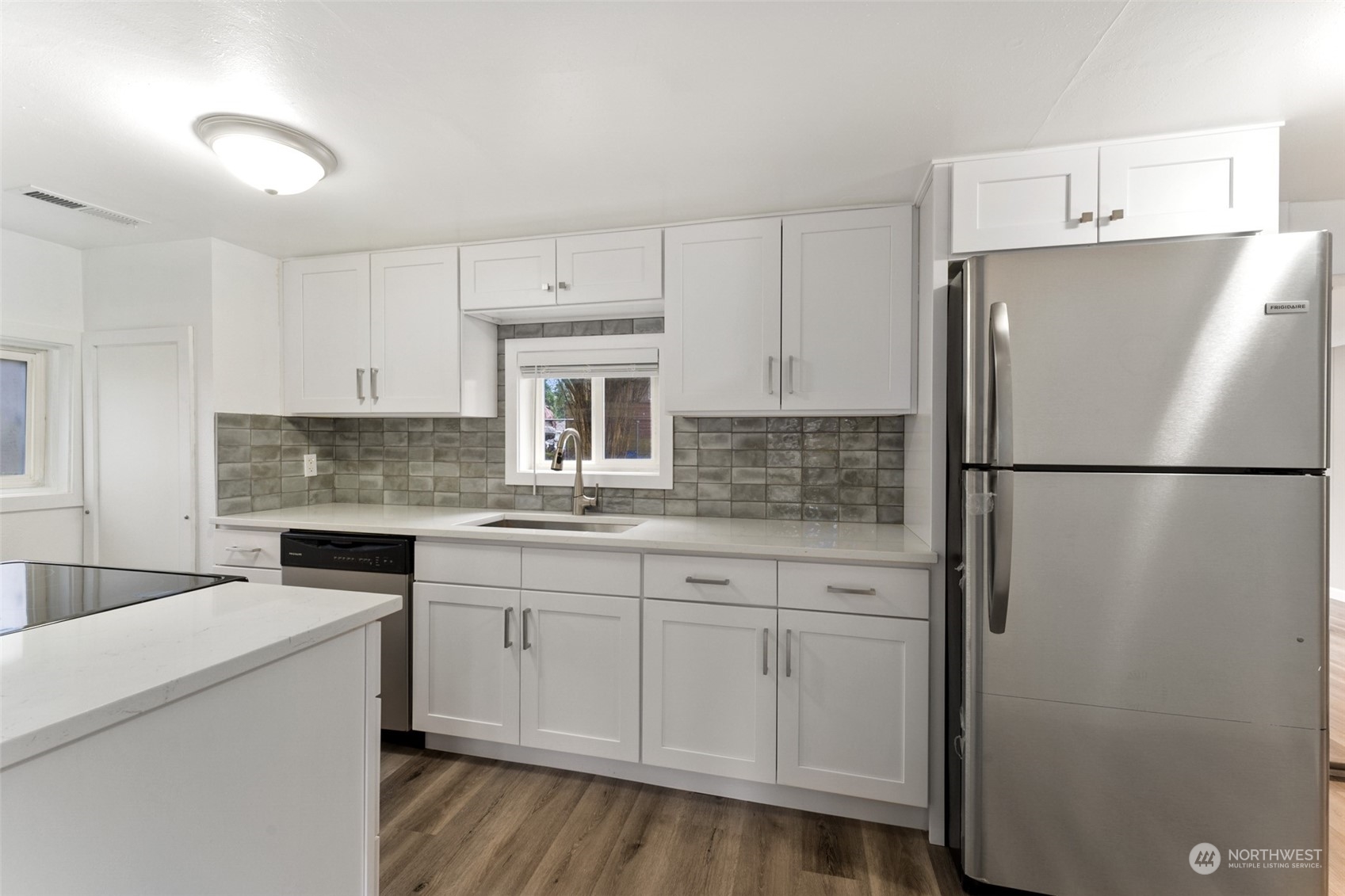 8520 Meadow Road Southwest Lakewood, WA 98499 - Photo 8 of 24 a kitchen with stainless steel appliances a refrigerator sink and cabinets