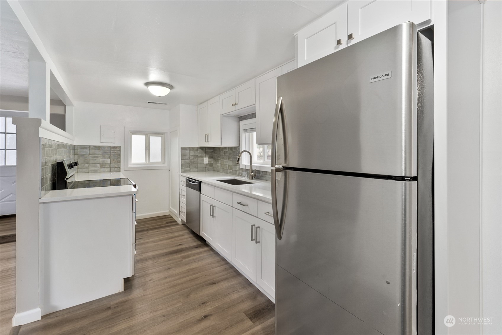 8520 Meadow Road Southwest Lakewood, WA 98499 - Photo 9 of 24 a kitchen with white cabinets and white appliances