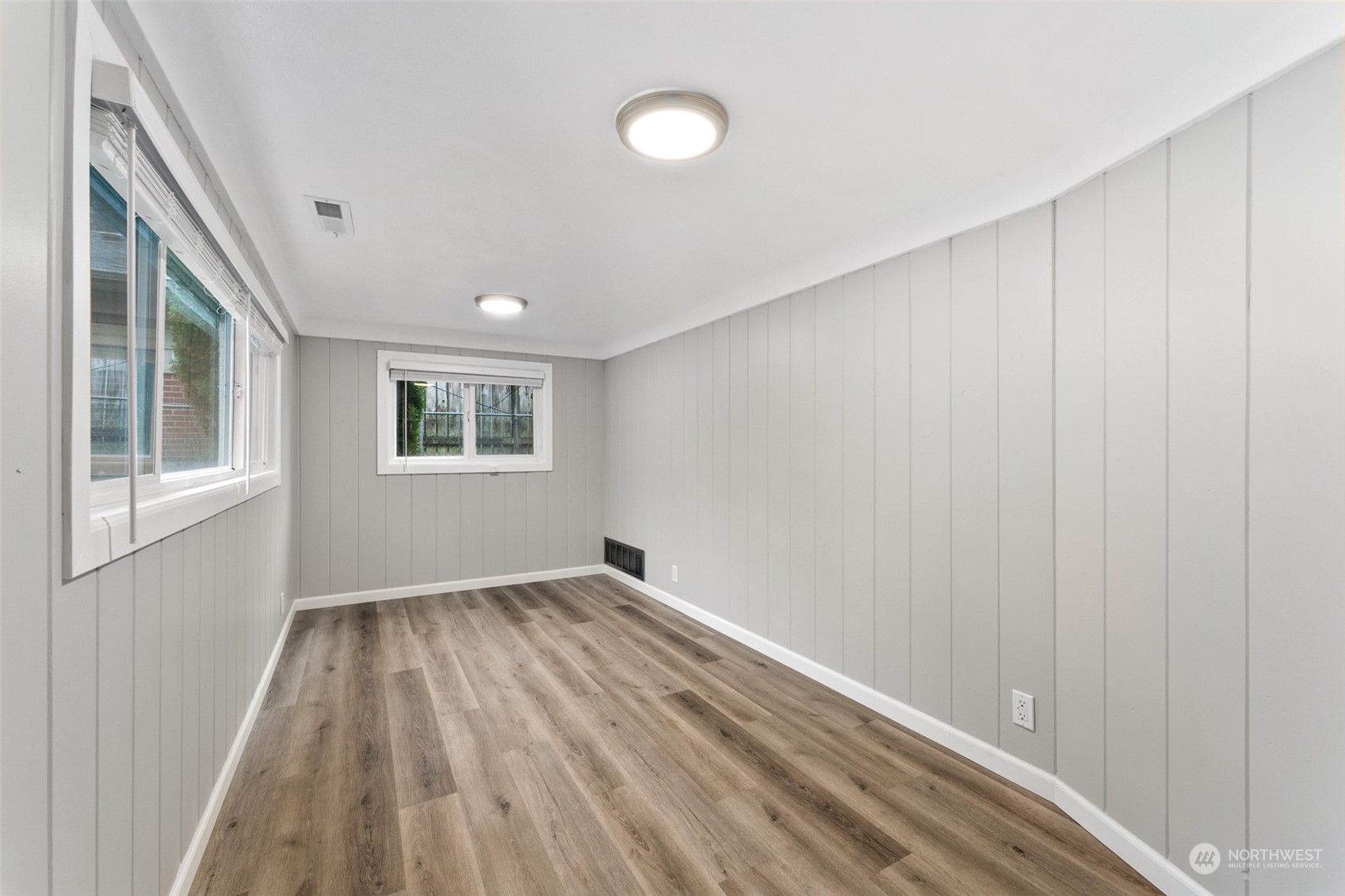 8520 Meadow Road Southwest Lakewood, WA 98499 - Photo 10 of 24 a view of an empty room with a window and wooden floor