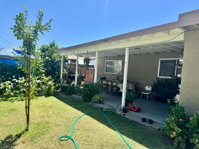 a view of a house with porch and a garden