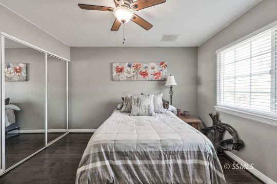 1267 North Erwin Street Ridgecrest, CA 93555 - Photo 26 of 35 a bedroom with a bed and a chandelier
