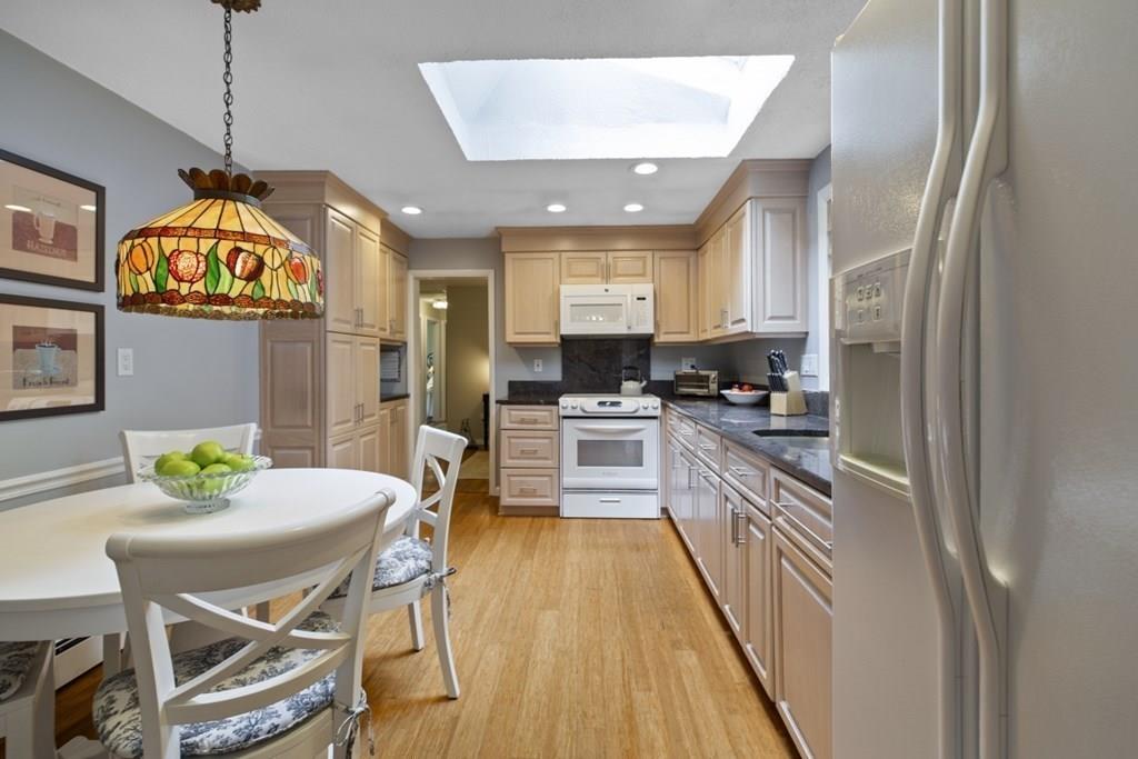 30 Larnis Road Framingham, MA 01701 - Photo 12 of 42 a kitchen with stainless steel appliances granite countertop a stove a sink and a refrigerator