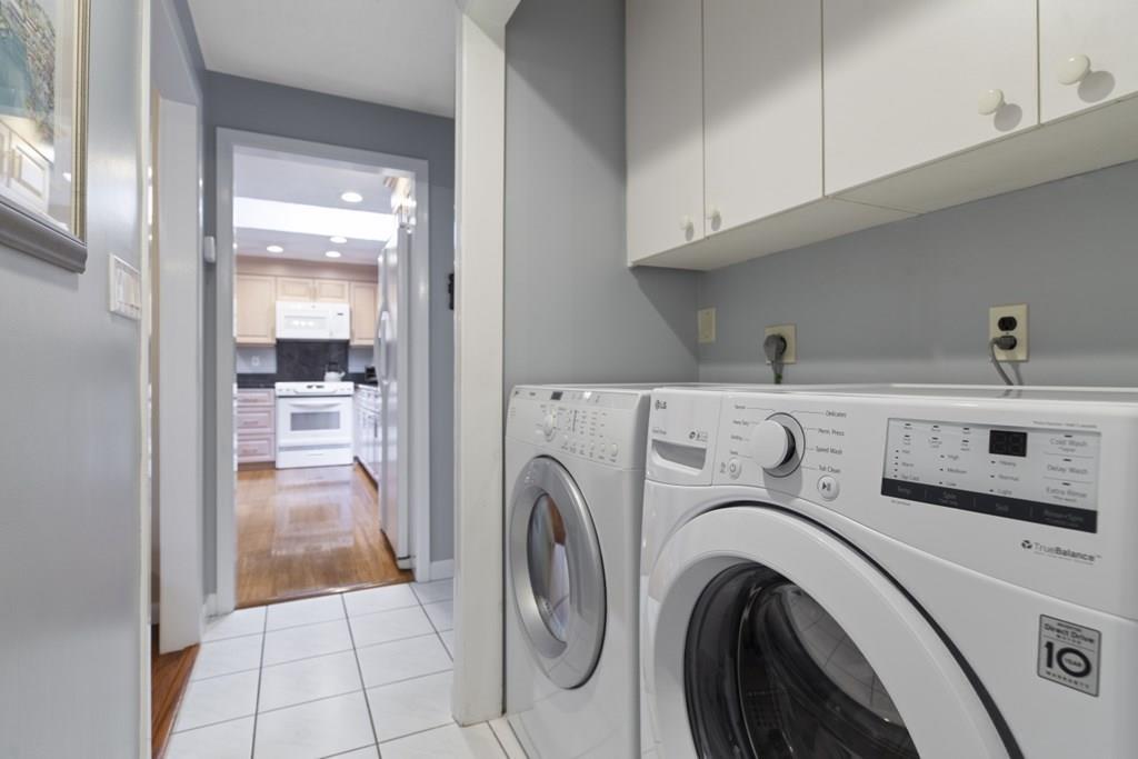 30 Larnis Road Framingham, MA 01701 - Photo 34 of 42 a view of washer and dryer with kitchen in the background