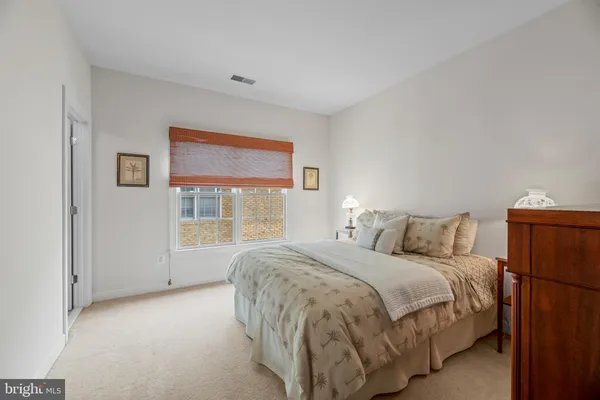 a bed room with a bed and a window