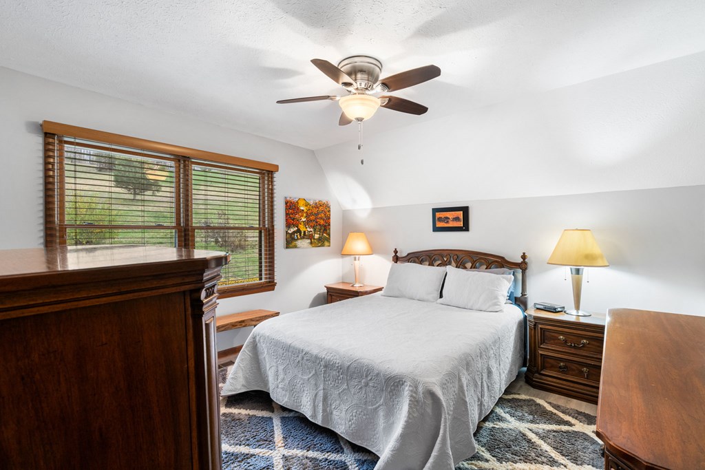 1721 Settlement Road Young Harris, GA 30582 - Photo 16 of 54 a bedroom with a bed and window
