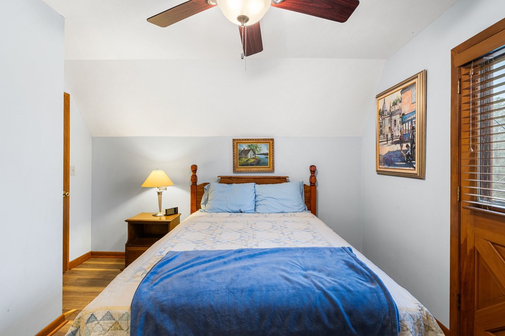 1721 Settlement Road Young Harris, GA 30582 - Photo 20 of 54 a bed sitting in a bedroom next to a window