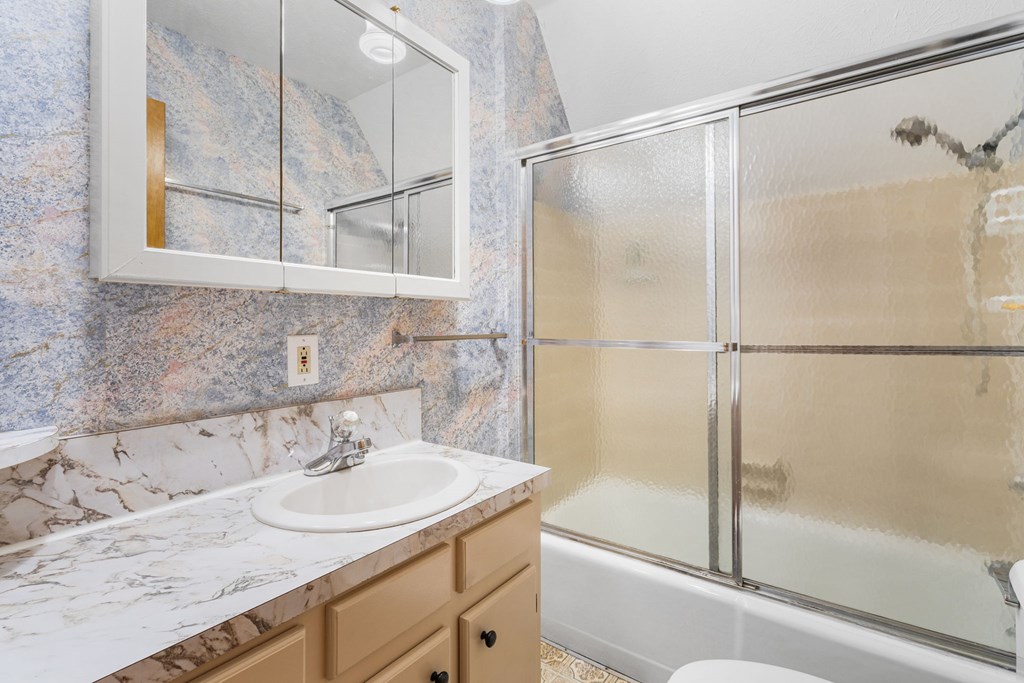1721 Settlement Road Young Harris, GA 30582 - Photo 23 of 54 a bathroom with a granite countertop sink mirror and a bathtub