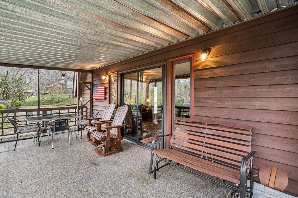 1721 Settlement Road Young Harris, GA 30582 - Photo 34 of 54 a view of a patio with table and chairs next to a yard