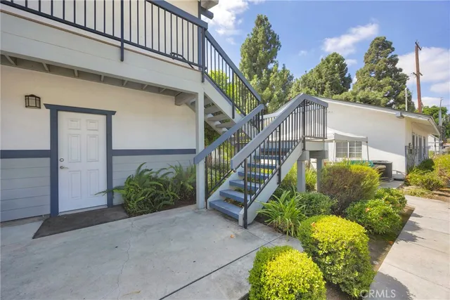 a kitchen with stainless steel appliances a table and chairs in it