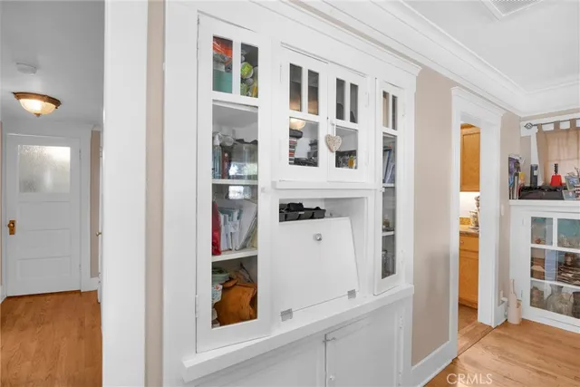 a large kitchen with stainless steel appliances granite countertop a refrigerator a sink dishwasher a stove and white countertops with wooden floor