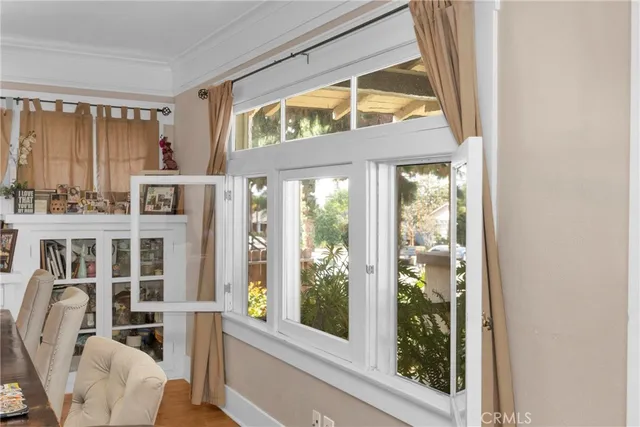 a kitchen with granite countertop wooden cabinets stainless steel appliances and a window