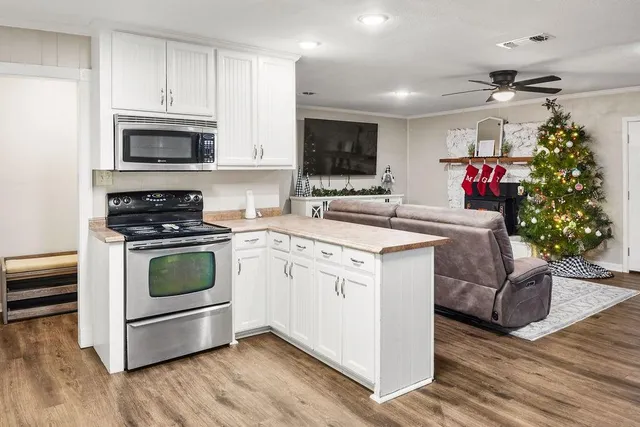 a kitchen with a sink stove and microwave