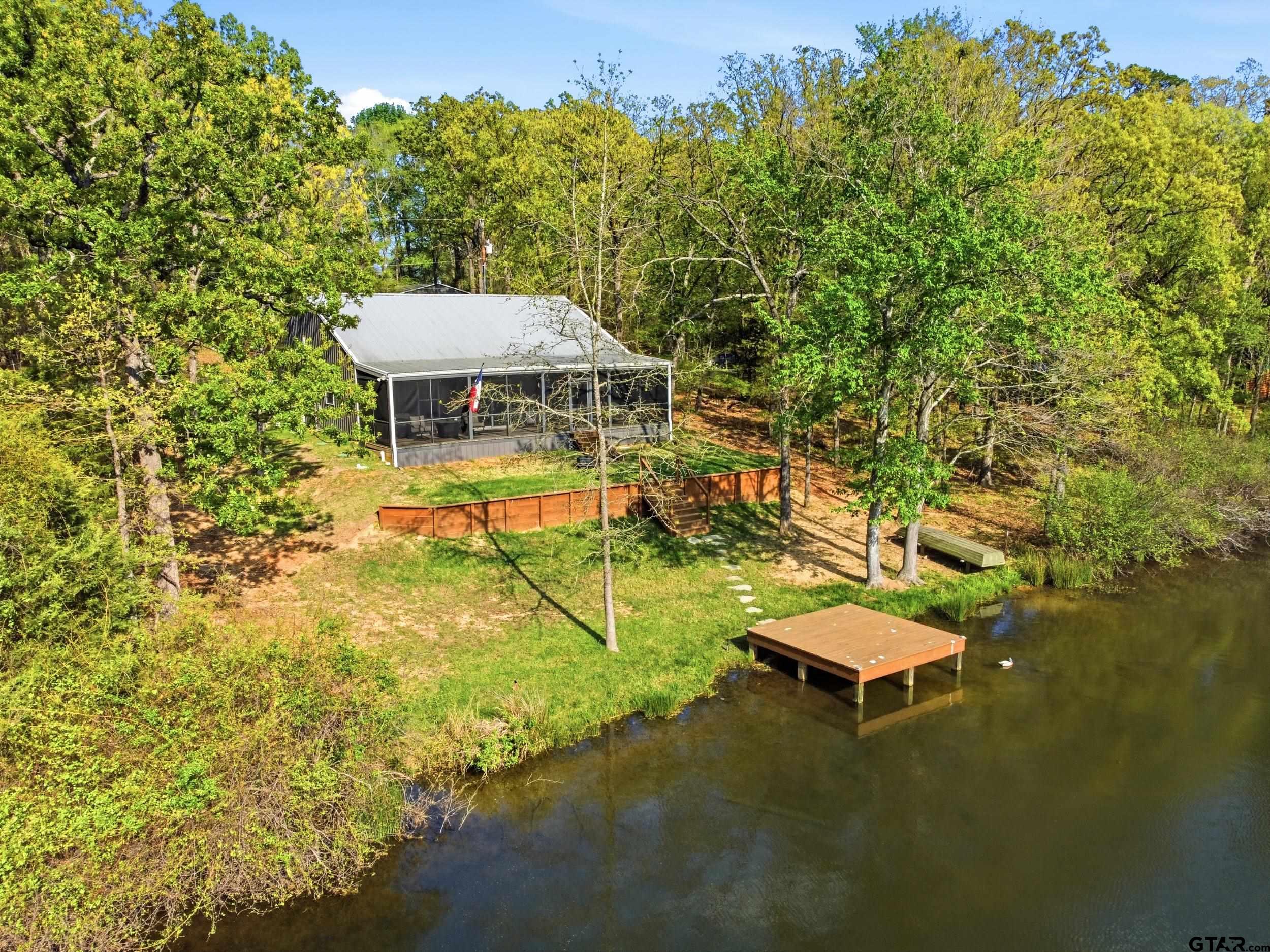 132 King George Road Scroggins, TX 75480 - Photo 32 of 35 a view of a swimming pool with a yard and seating area