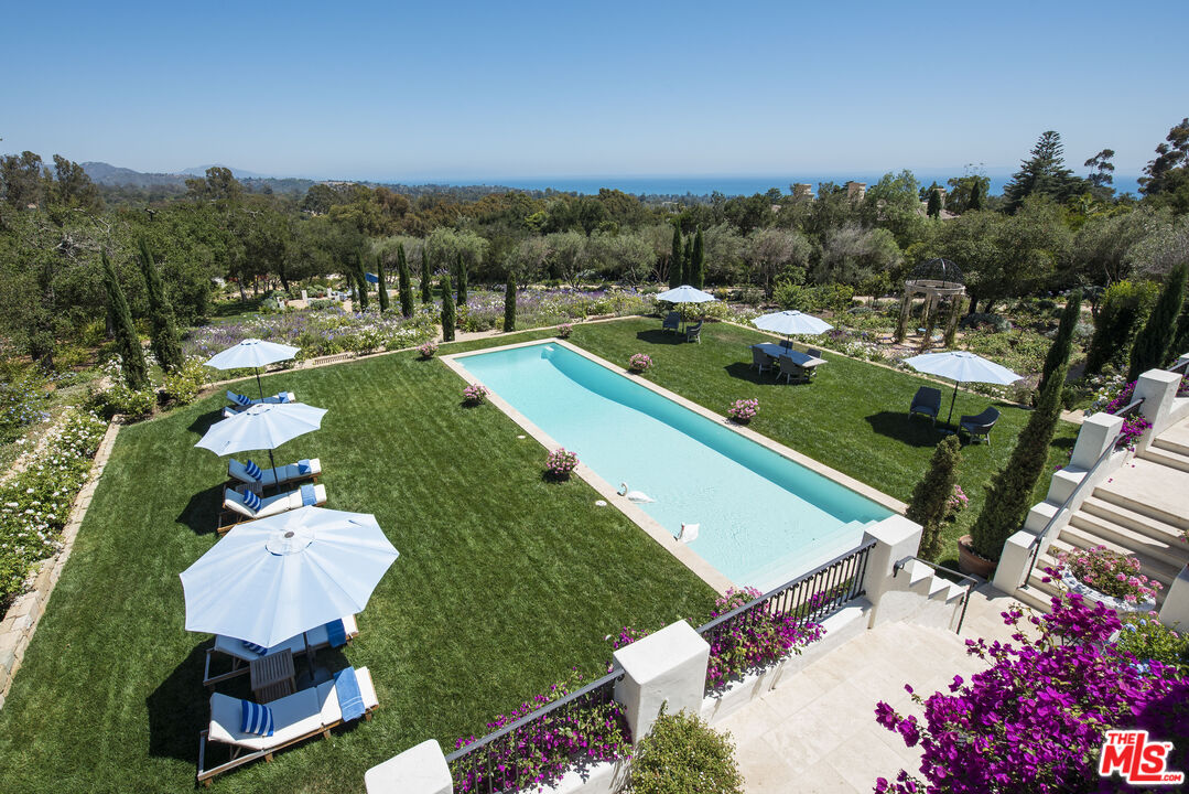 848 Picacho Lane Montecito, CA 93108 - Photo 21 of 22 a view of a swimming pool with a table and chairs