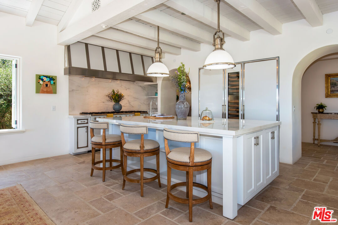 848 Picacho Lane Montecito, CA 93108 - Photo 7 of 22 a dinning area with stainless steel appliances kitchen island granite countertop a table chairs in it and a window
