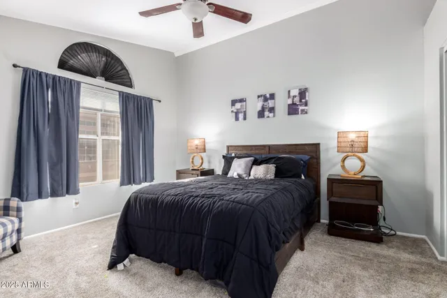 a bedroom with a bed and a window