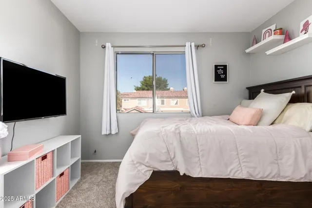 a bedroom with a bed and a flat screen tv