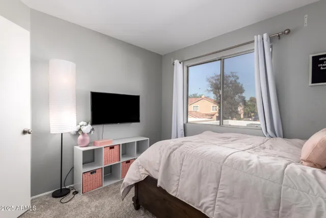a bedroom with a bed and a flat screen tv