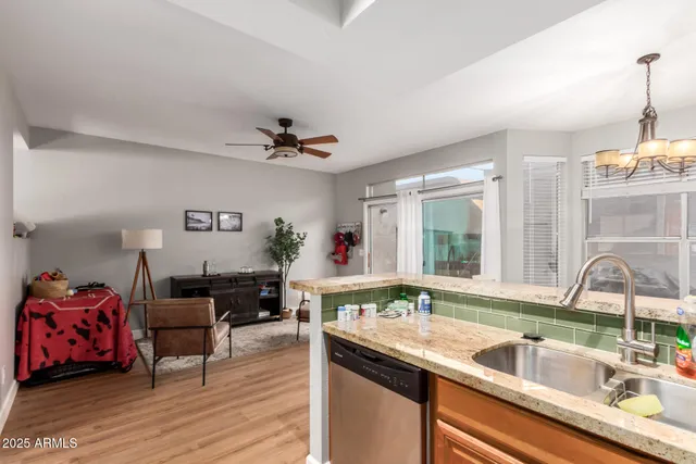 a kitchen with a sink stove and wooden floor
