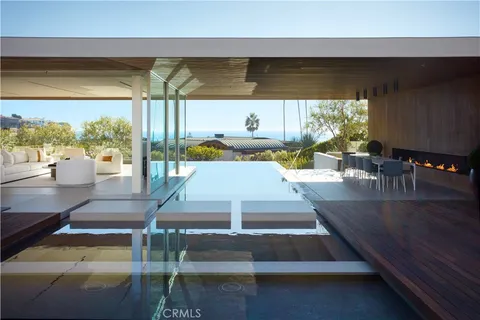 a view of a swimming pool with chairs in patio