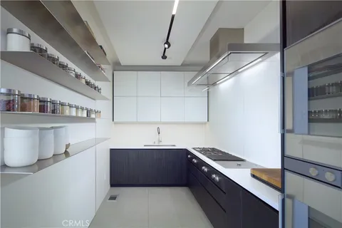 a kitchen with stainless steel appliances granite countertop a sink stove and cabinets