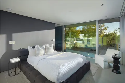 a bedroom with a bed and large window