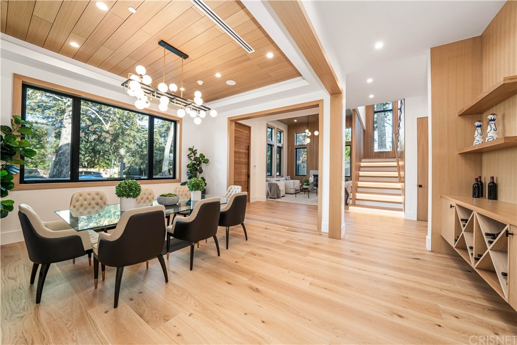 11201 Valley Spring Lane Studio City, CA 91602 - Photo 4 of 14 a dining room with furniture a chandelier and wooden floor