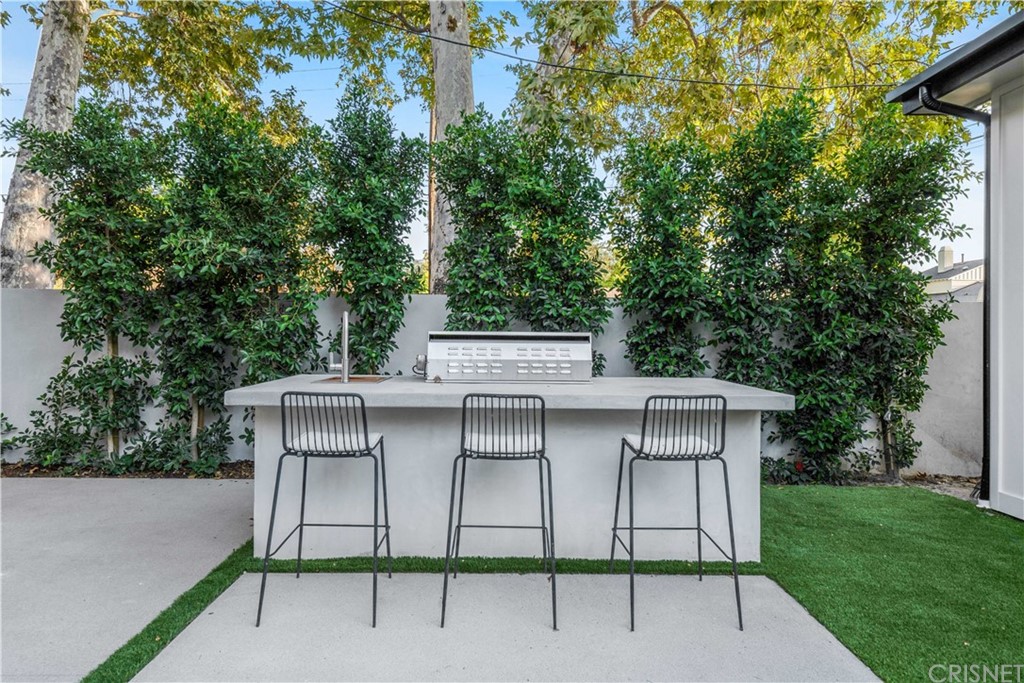 11201 Valley Spring Lane Studio City, CA 91602 - Photo 10 of 14 a view of a chairs and table in the back yard of the house