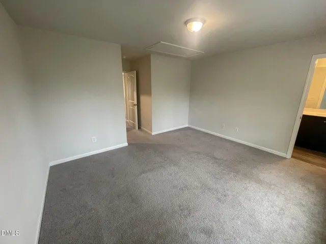 a view of an empty room and a window