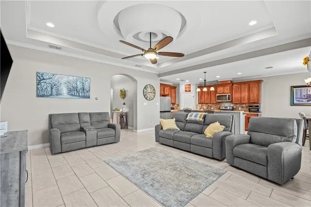 a living room with furniture and a chandelier