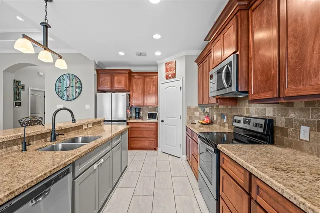 a kitchen with stainless steel appliances granite countertop a sink and stove