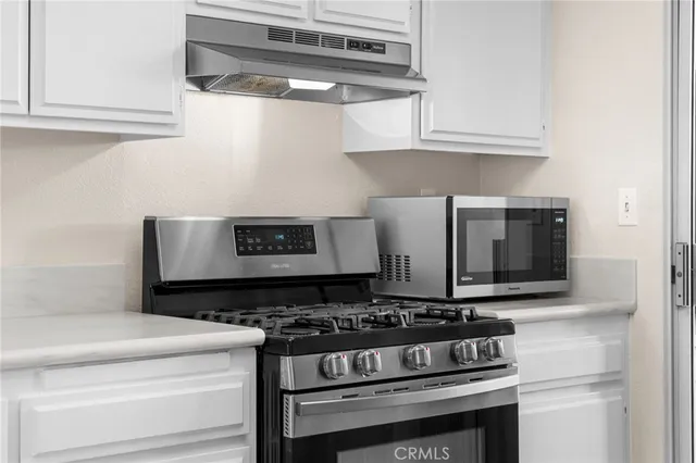 a stove top oven sitting inside of a kitchen