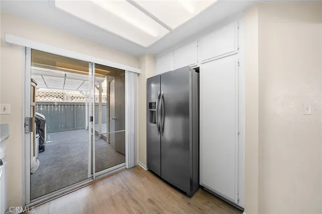 a view of a refrigerator in kitchen and wooden floor