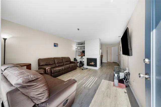 a living room with furniture fireplace and flat screen tv