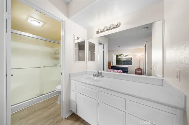 a spacious bathroom with a shower sink and mirror