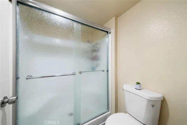 a bathroom with a shower and a toilet