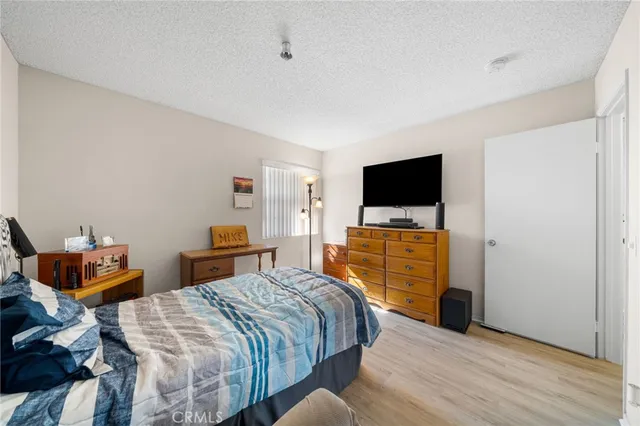 a bedroom with a bed and flat screen tv