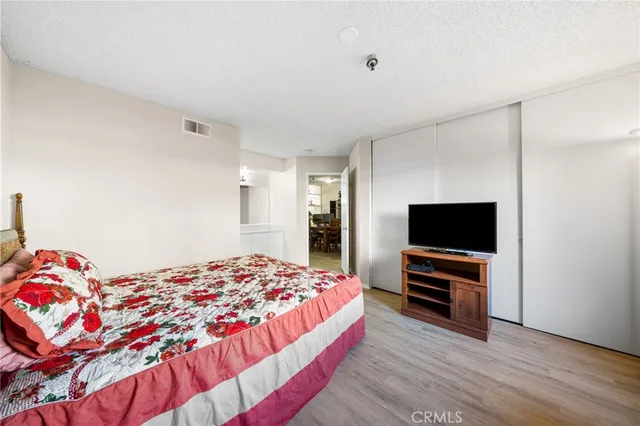 a bedroom with a bed and a flat screen tv