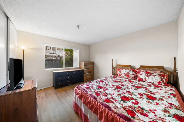 a bedroom with a bed and a flat screen tv