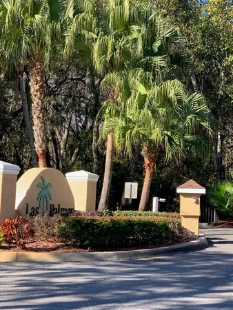 a view of a house with a yard and tree s