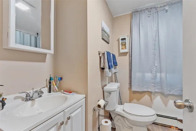 a bathroom with a toilet a sink and a mirror