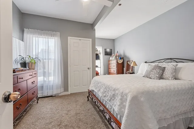 a bedroom with bed and window