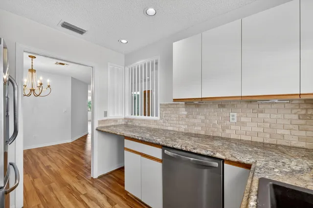 a kitchen with stainless steel appliances a stove sink microwave and cabinets