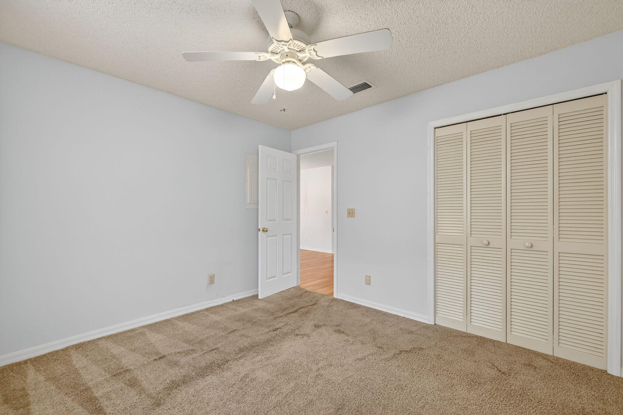 6101 Southeast Landing Way, Unit 11 Stuart, FL 34997 - Photo 25 of 55 an empty room with chandelier fan