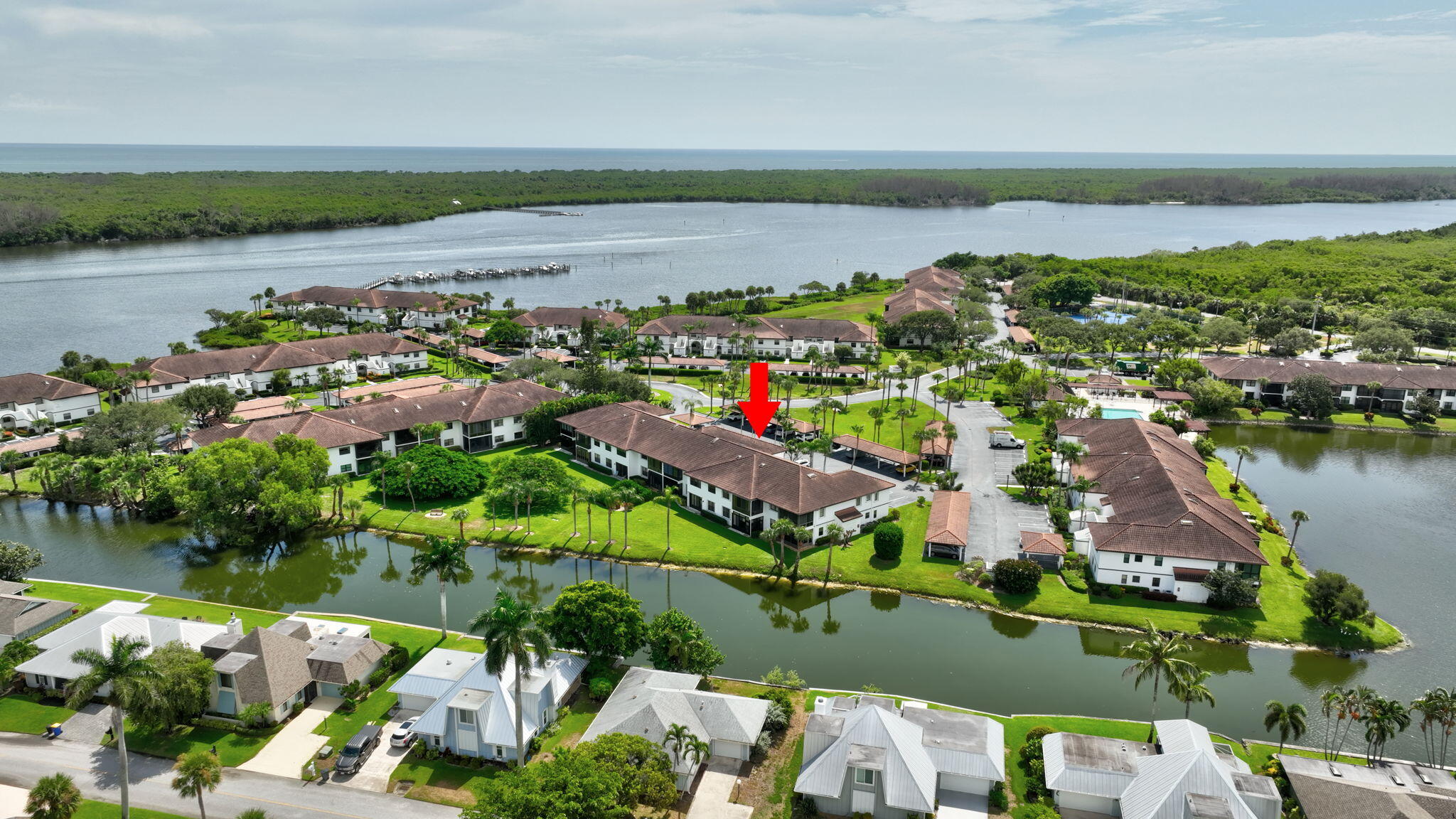 6101 Southeast Landing Way, Unit 11 Stuart, FL 34997 - Photo 35 of 55 an aerial view of lake and residential houses with outdoor space and lake view