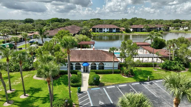 an aerial view of a house with a garden and lake view