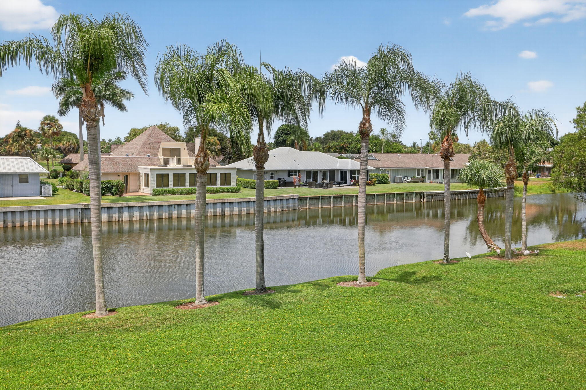 6101 Southeast Landing Way, Unit 11 Stuart, FL 34997 - Photo 5 of 55 a view of a house with a yard and a palm tree