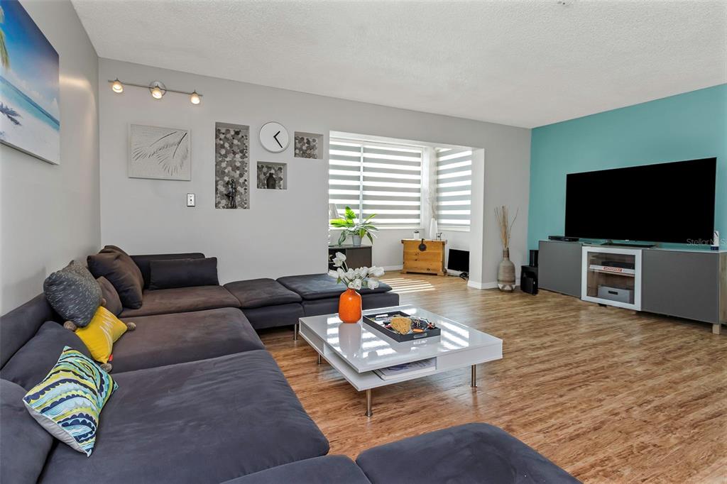 1900 68th Street North, Unit 110 St. Petersburg, FL 33710 - Photo 12 of 48 a living room with furniture and a flat screen tv