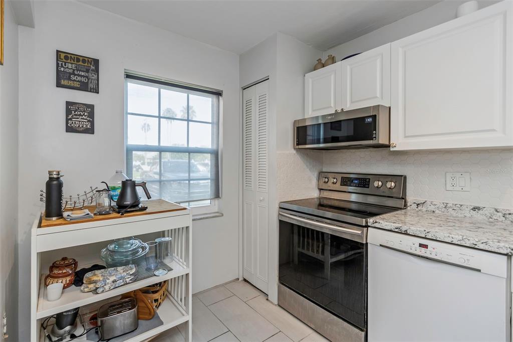1900 68th Street North, Unit 110 St. Petersburg, FL 33710 - Photo 19 of 48 a kitchen with white cabinets and appliances
